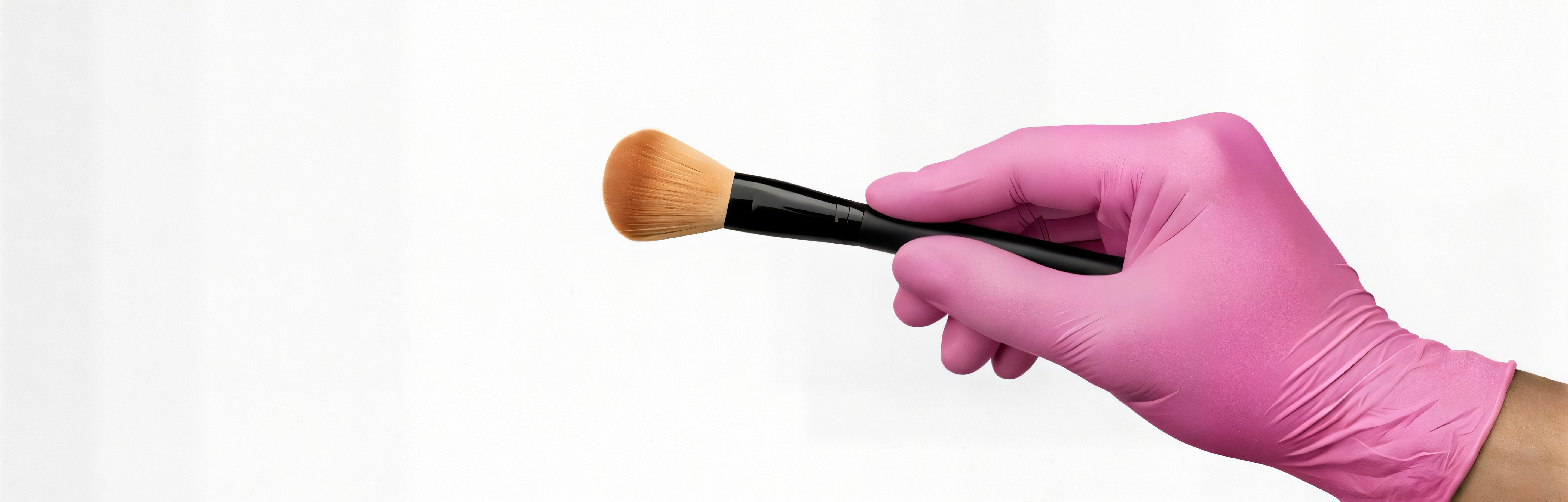 Hand wearing Fuschia SwiftGrip EN35F Series Gloves while holding a brush